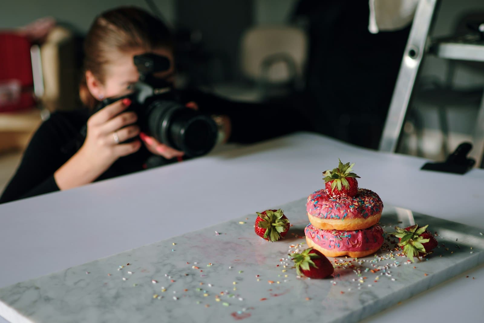 Photographer shooting product photos on a studio table