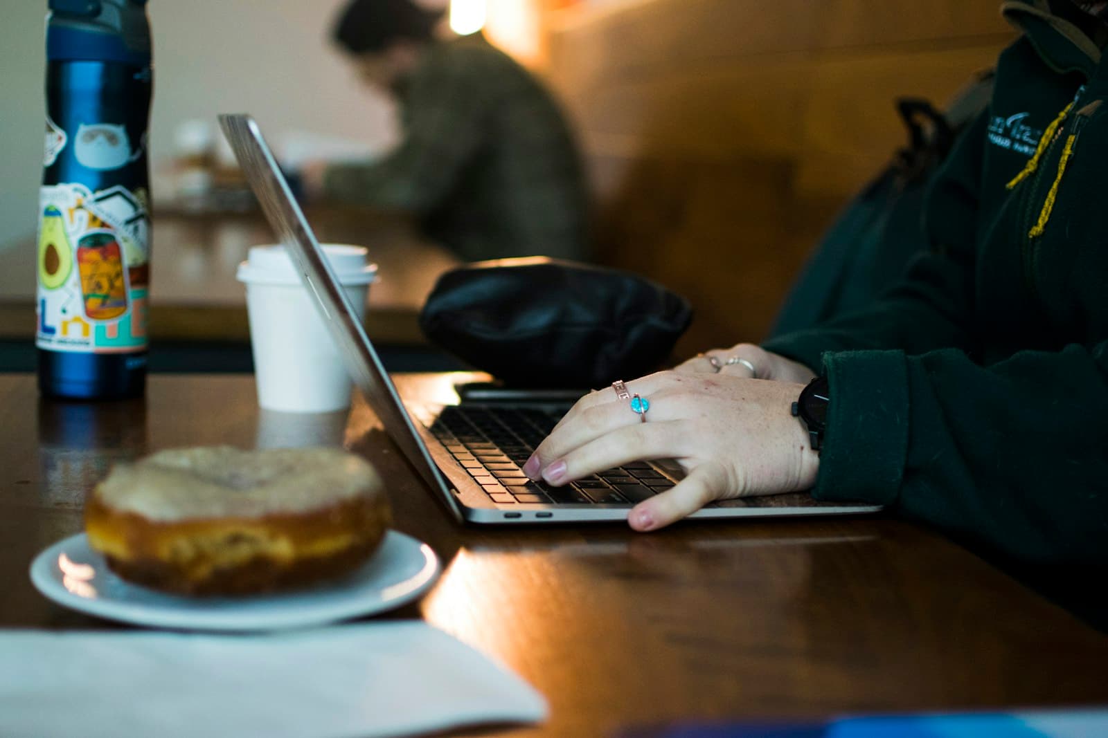 Reading and taking notes on a laptop over coffee