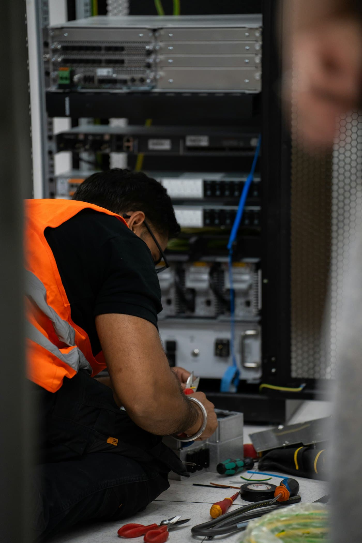 Technician servicing equipment in a server rack