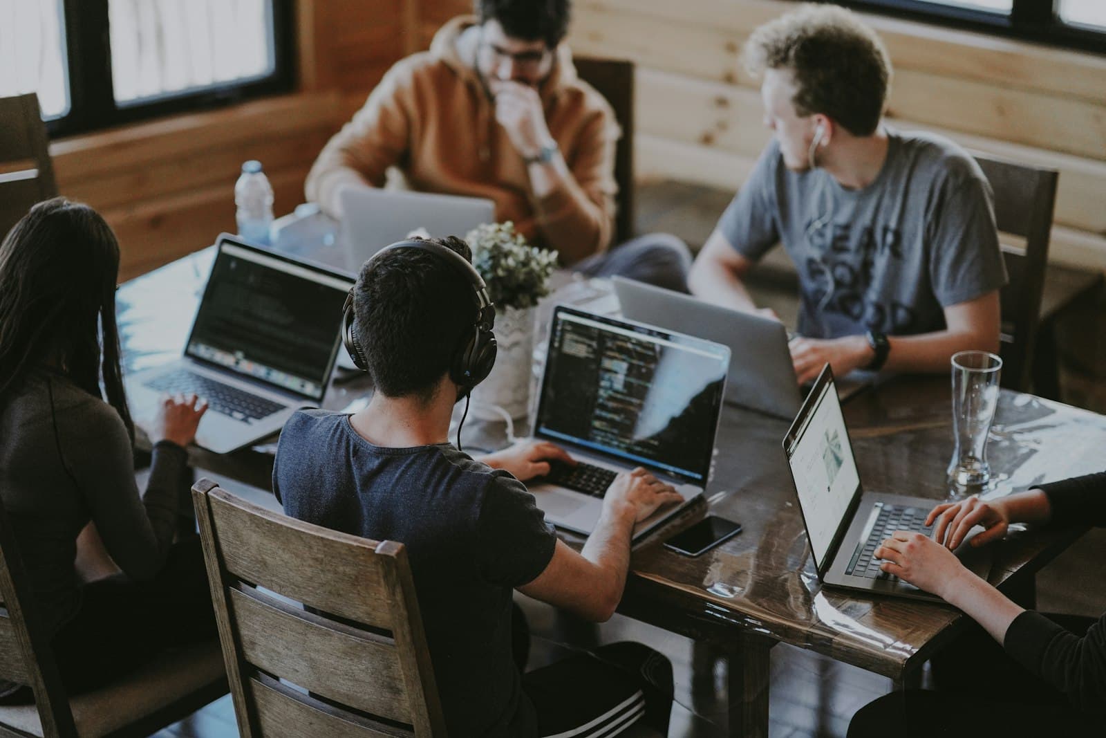 A small engineering team working side by side on laptops